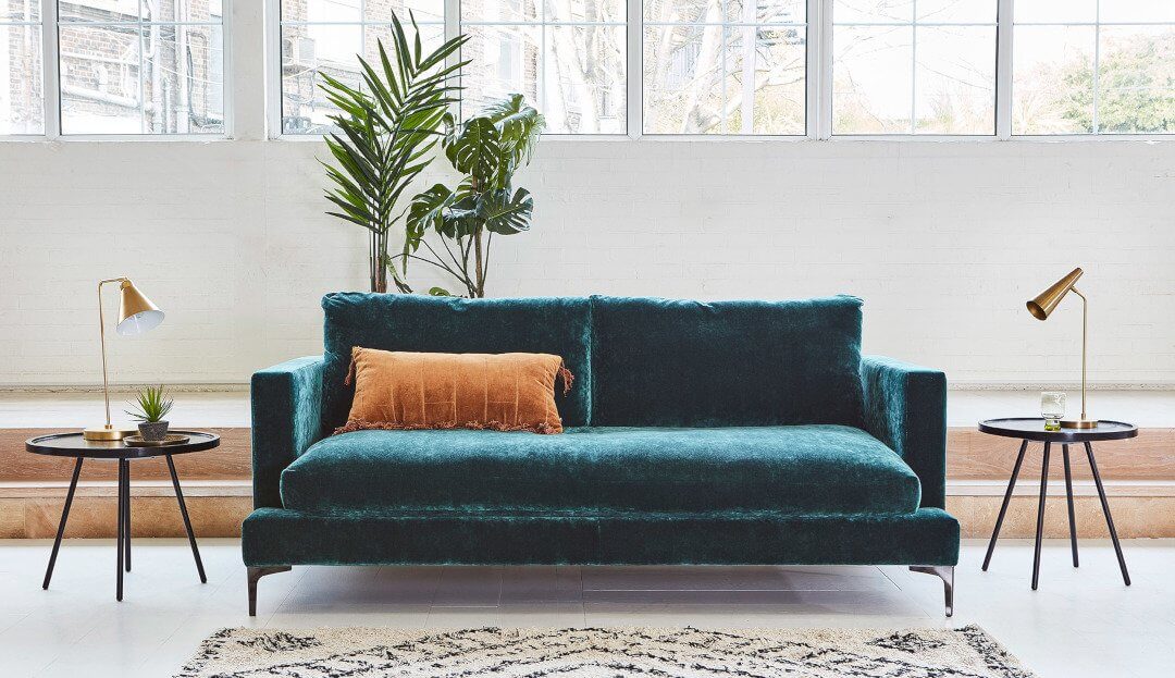 large sofa in crushed green velvet